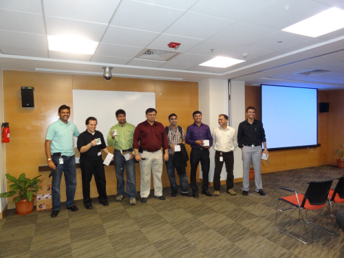Group photo with certificates and a projector screen.