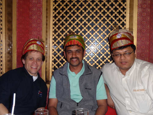 Three men wearing traditional headgear.