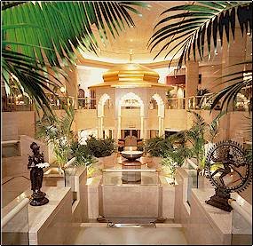 Elegant lobby with greenery and sculptures.