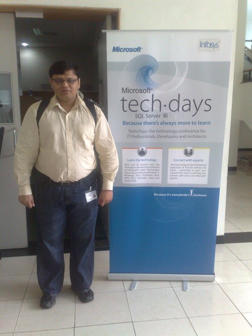 A man standing beside a Microsoft TechDays sign.