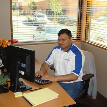 Person typing on a computer keyboard.